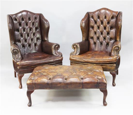 A pair of George III style brown leather and brass studded wingback armchairs, foot stool 3ft 4in. x 2ft 4.5in.